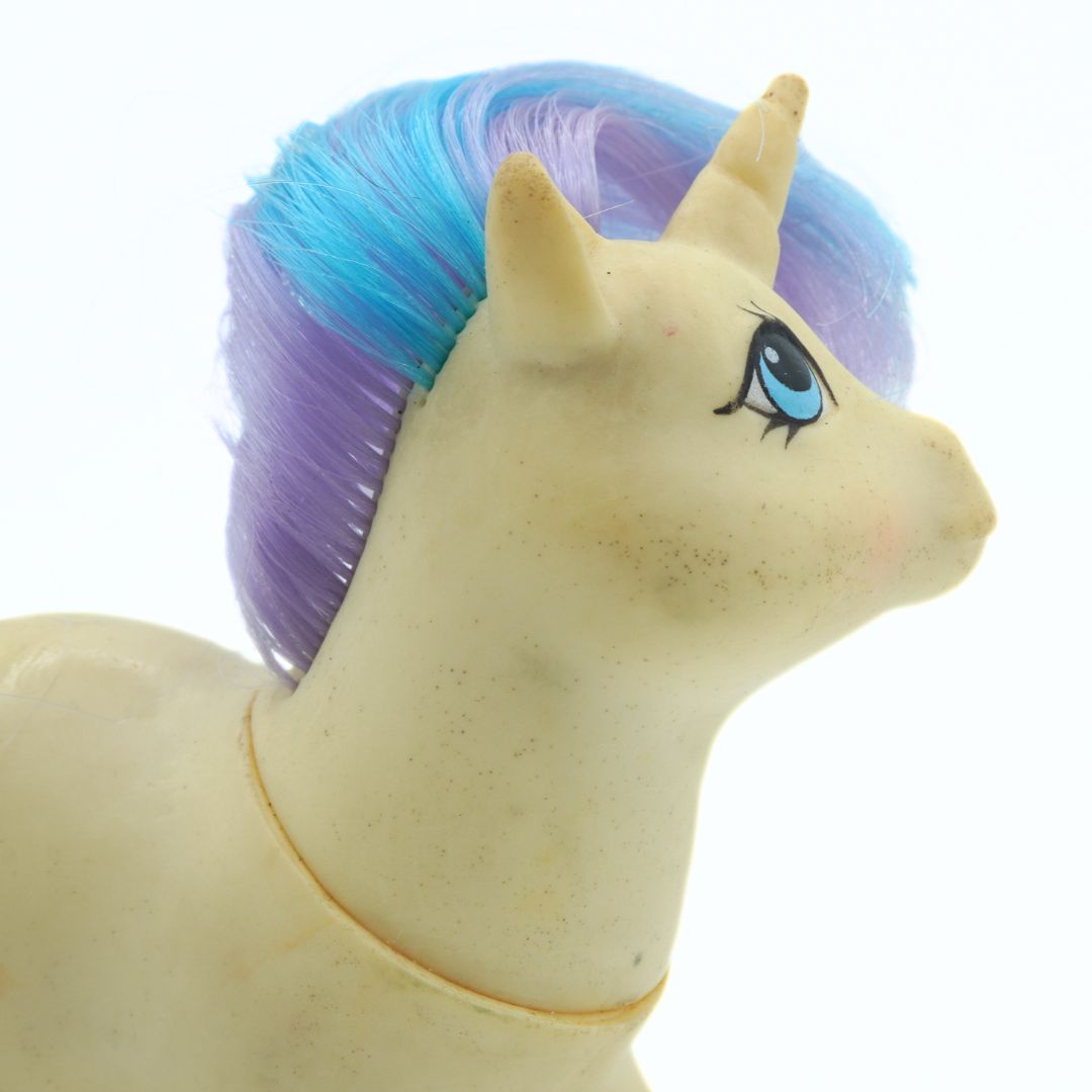 Toy unicorn with blue and purple hair on a white background