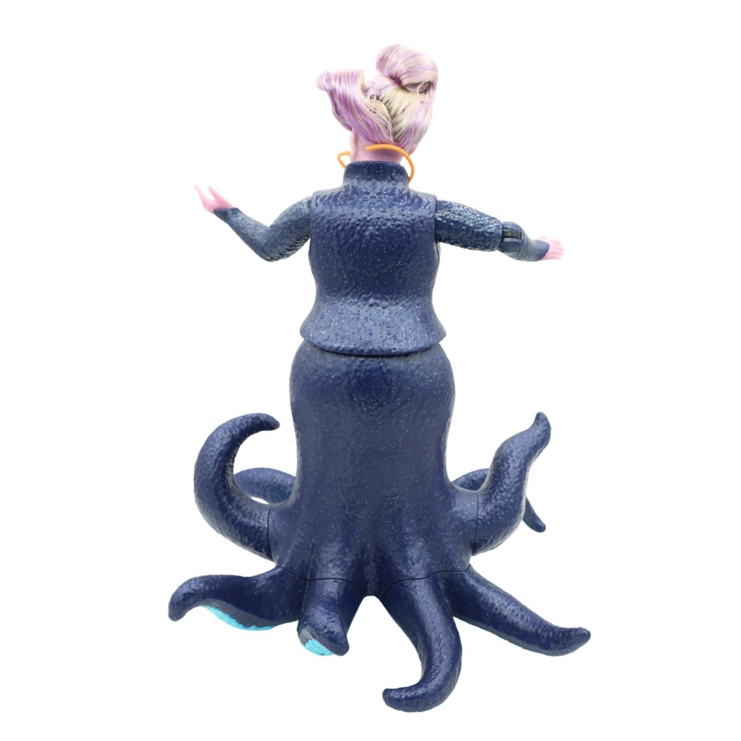 Ursula doll wearing a dark blue dress and with purple hair