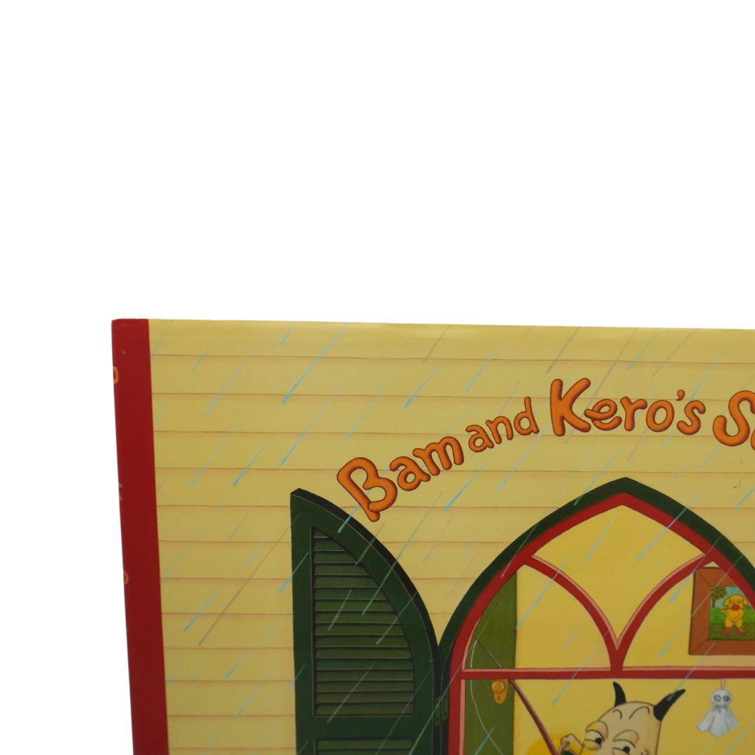Children's picture book titled 'Bam and Kero's Sunday' with a cream-colored lined-paper cover design, featuring an illustration of a dog at an open window and a red spine band.
