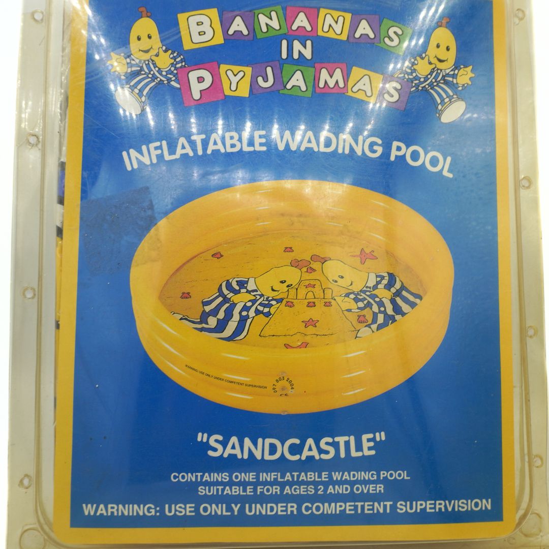 Inflatable wading pool packaging with 'Bananas in Pyjamas' branding on a blue background.