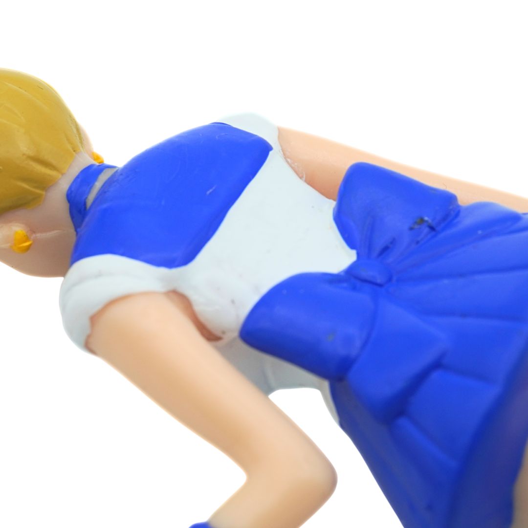 Toy figure of a character in a blue and white dress on a white background