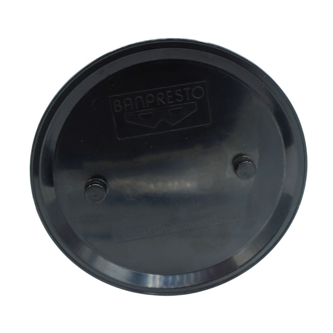 A round black plastic cap or cover with the brand name BANPRESTO embossed on the top, shown against a plain white background.