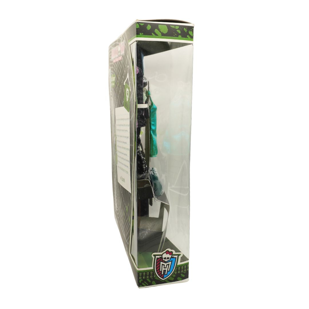 A boxed toy or collectible figure displayed in a tall clear plastic window box with green and black printed graphics on a white background.