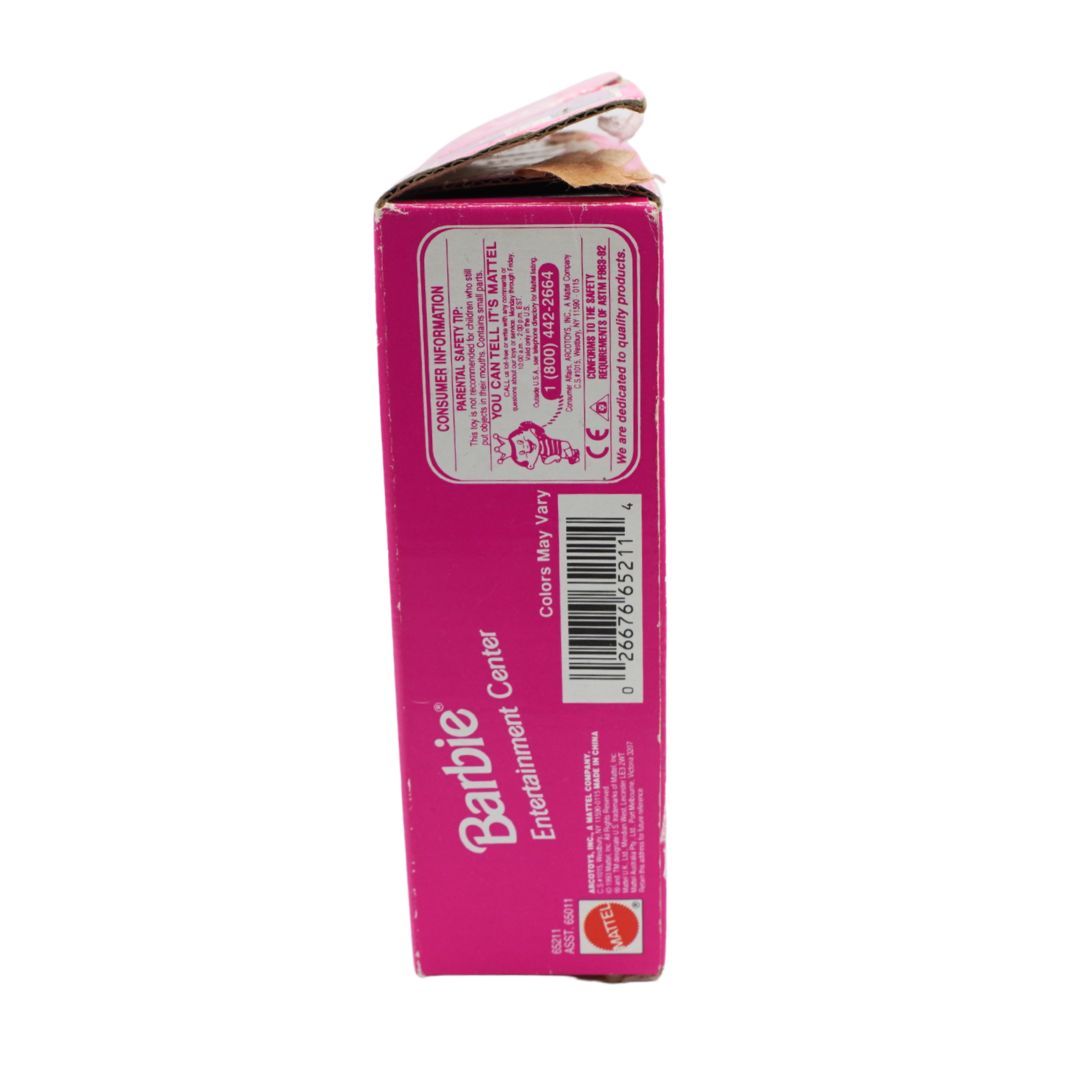 A pink Barbie Entertainment Center product box shown from the side on a plain white background, with printed text, a barcode, and the Barbie logo visible.
