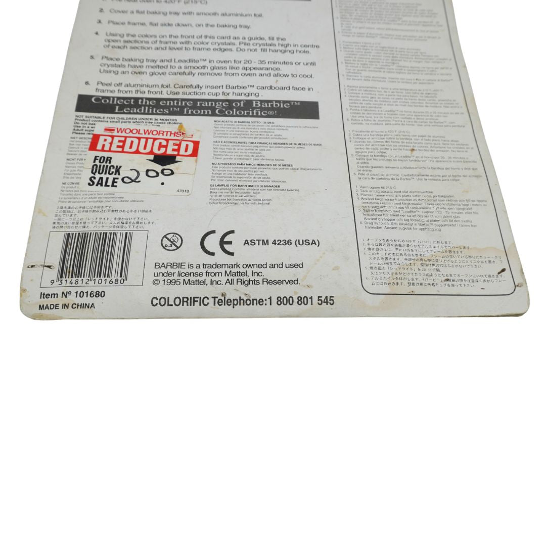The back of a Colorific baking pan packaging card, showing product information, instructions, barcodes, and a 'Reduced for Quick Sale' sticker on a white background.