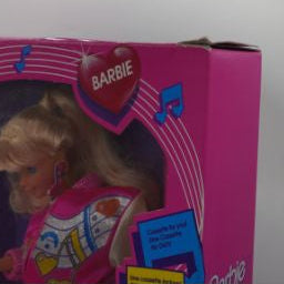 Pink toy box with a teddy bear inside on a white background