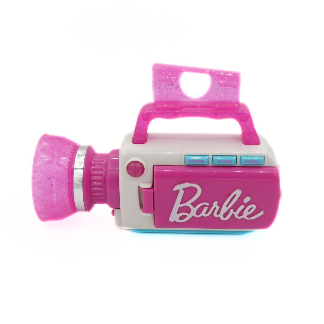 A pink and white toy camcorder featuring the Barbie logo on the side, set against a plain white background.