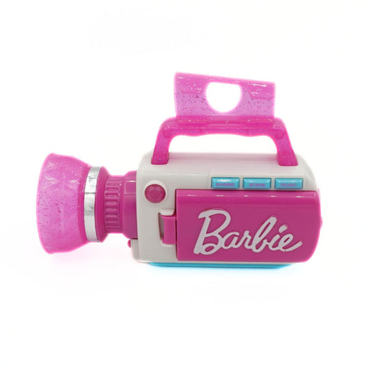 A pink and white toy camcorder featuring the Barbie logo on the side, set against a plain white background.