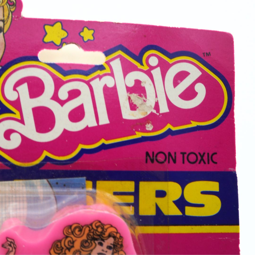 Damage to the Barbie logo on a vintage 1983 Barbie eraser