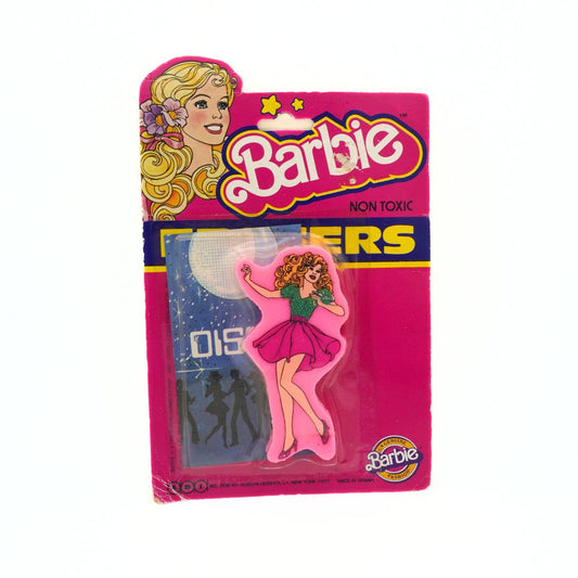 Vintage pink 1983 Barbie eraser with Barbie wearing a pink skirt and a sparkly green shirt