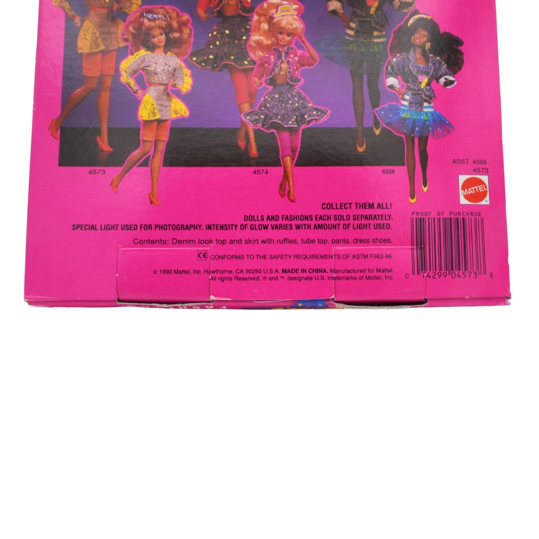 Back of a pink packaging with barbie dolls in glow in the dark outfits on a white background