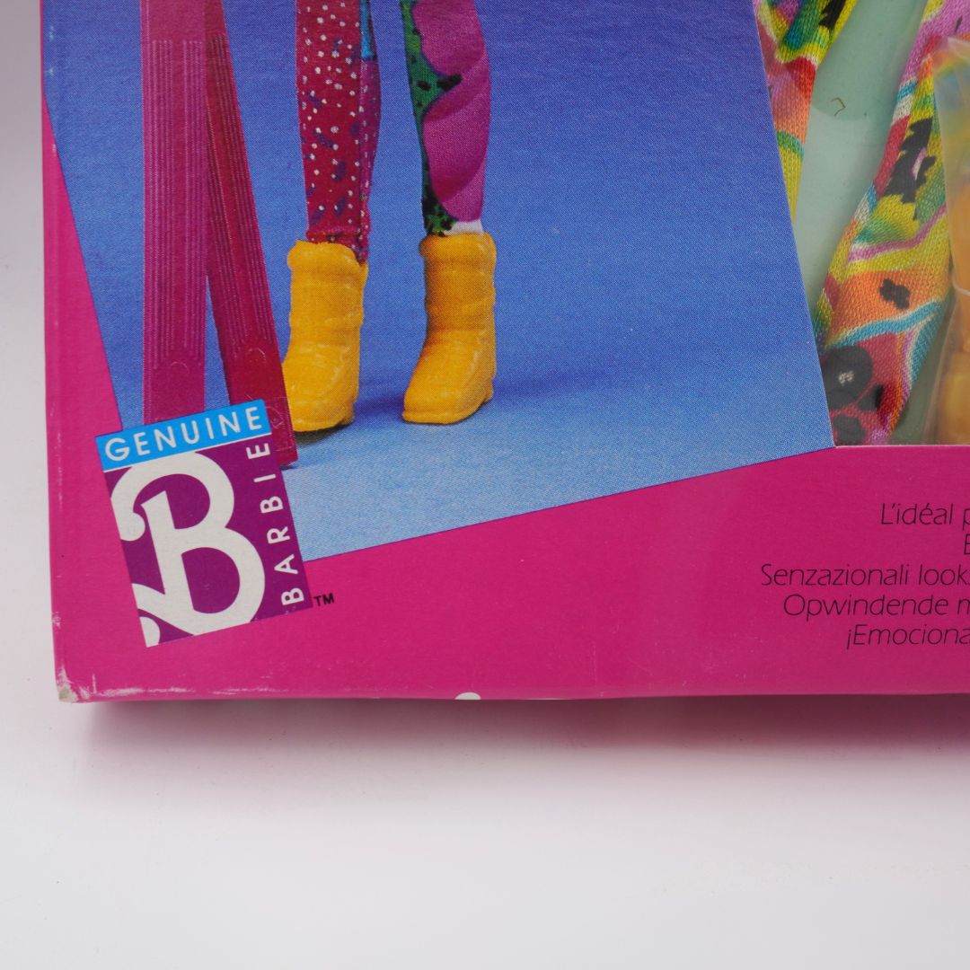 Barbie doll packaging with colorful outfit and yellow boots on a white background