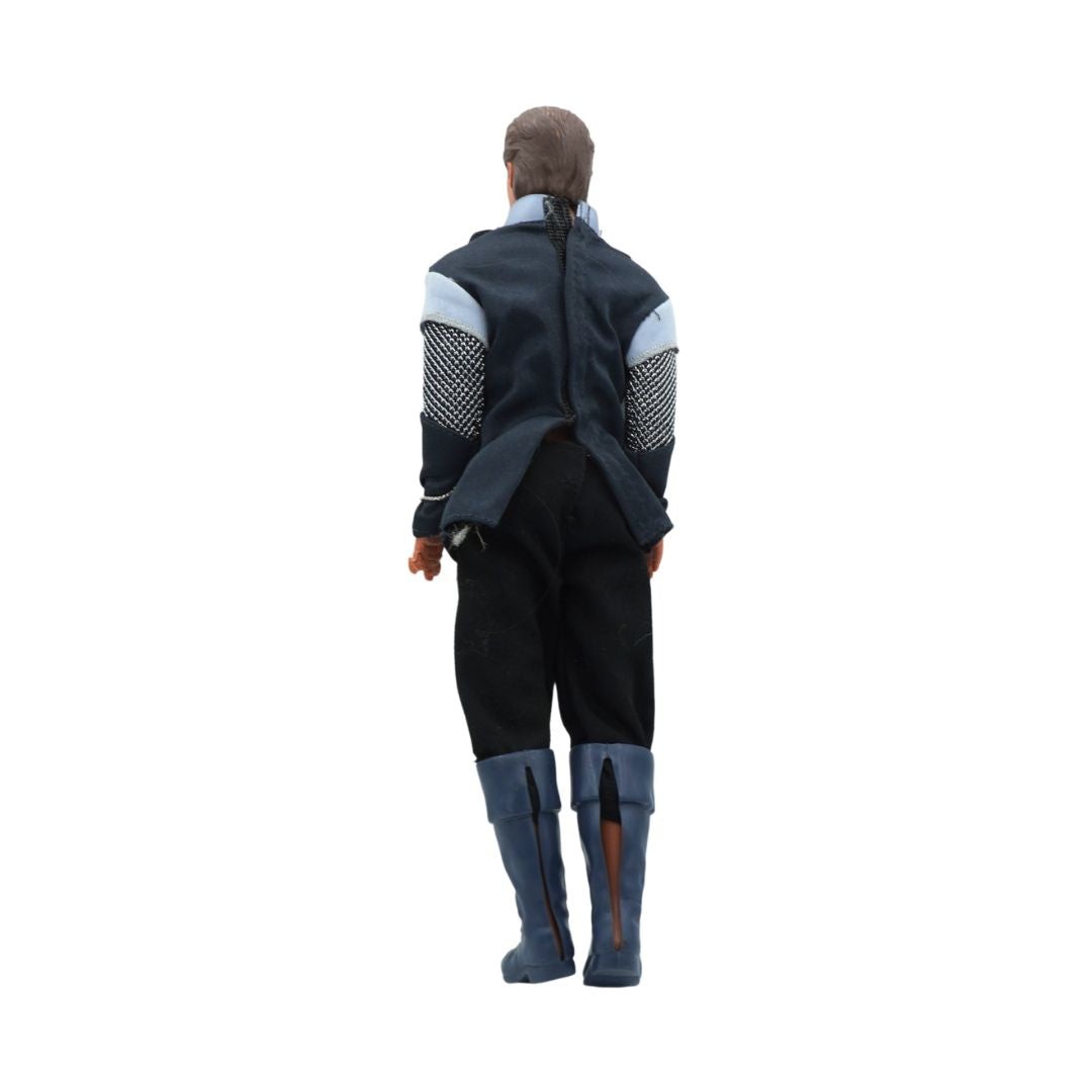 Person wearing a dark outfit with a cape on a white background