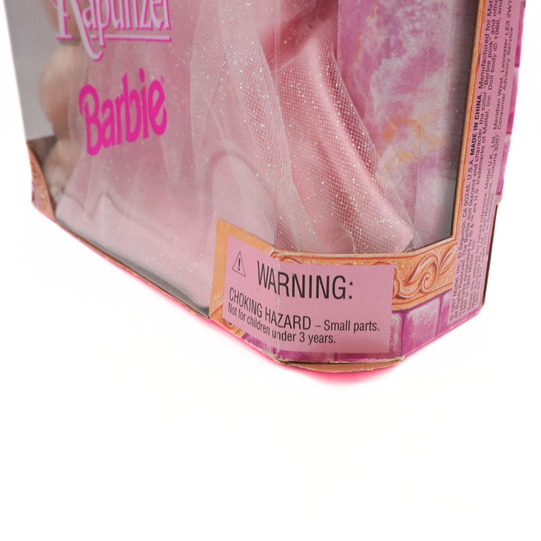 Barbie Rapunzel doll packaging with warning label on a white background