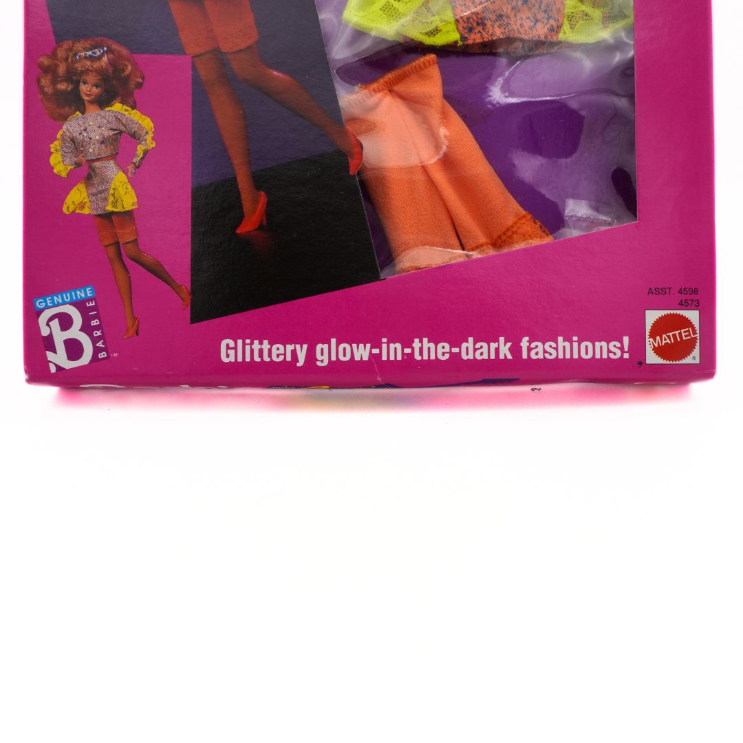 Barbie packaging with a doll and clothes, featuring 'Glow-in-the-dark' text.
