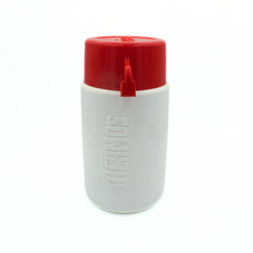 Back of a white Barbie Thermos with a red lid-cup