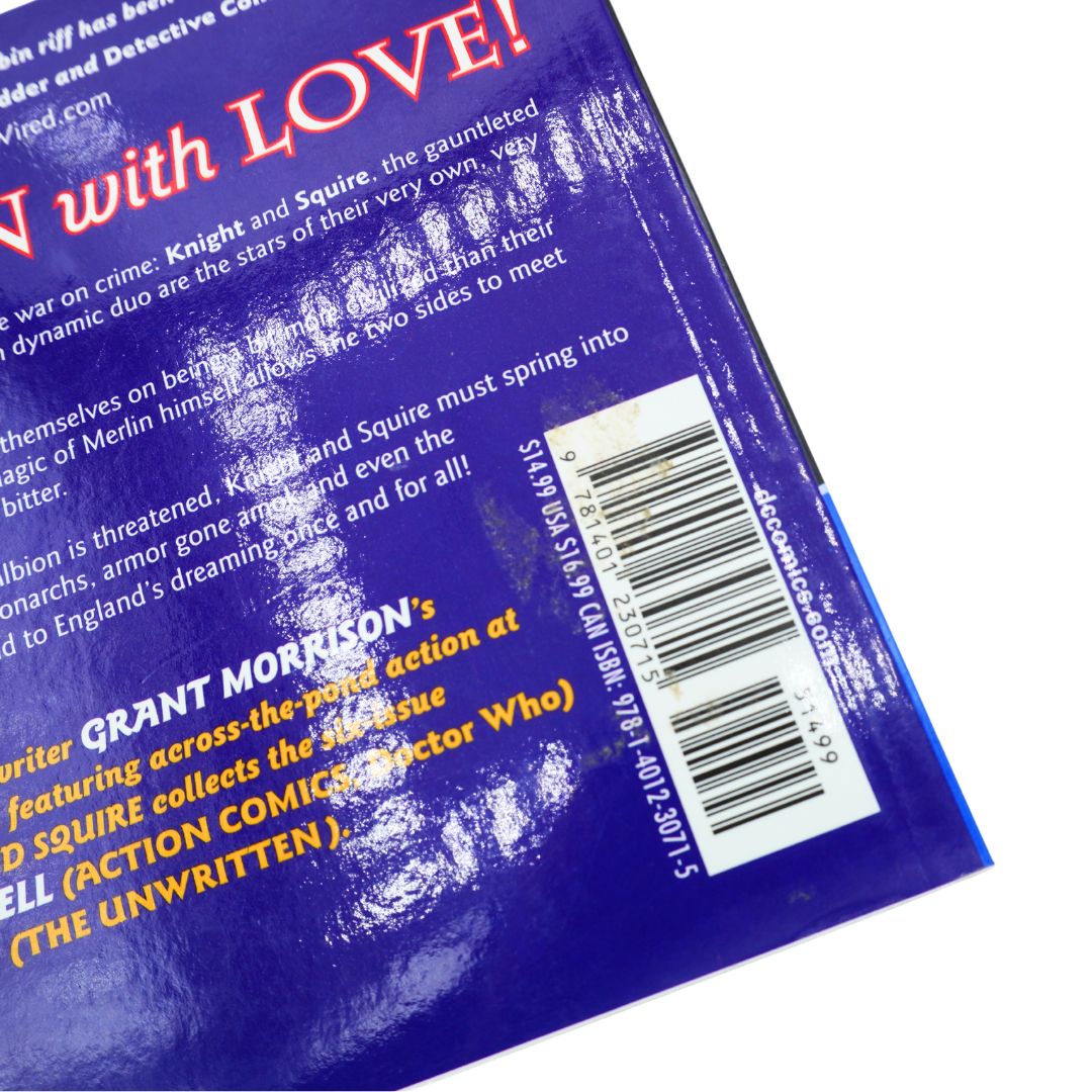 Close-up of the back cover of a book, showing a deep blue background with white and yellow text, a barcode, and a glossy finish with visible light reflections.