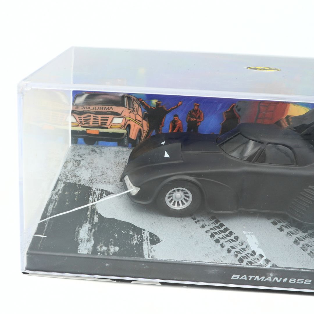 Model of a car in a clear display case with a colorful background