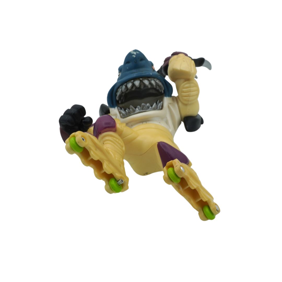 Toy figure of a shark-like character with boxing gloves on a white background
