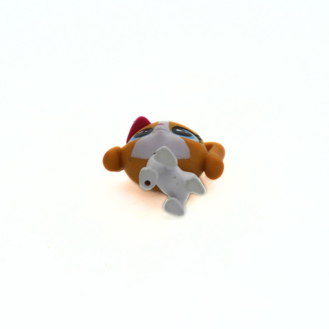 Toy figure of a dog with a red bow on a white background