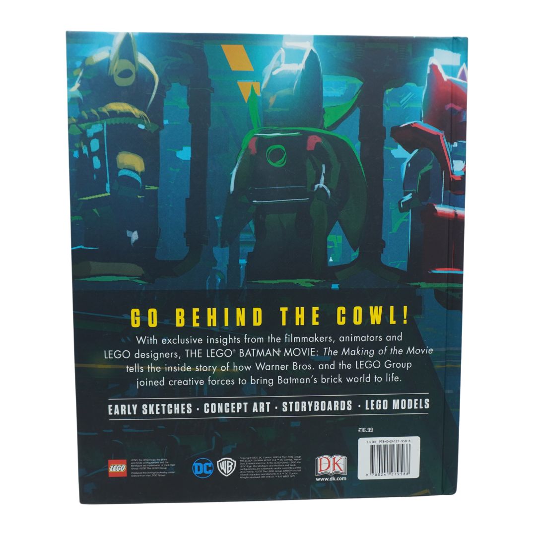 A blue book photographed against a white background showing Batman and Lego branding