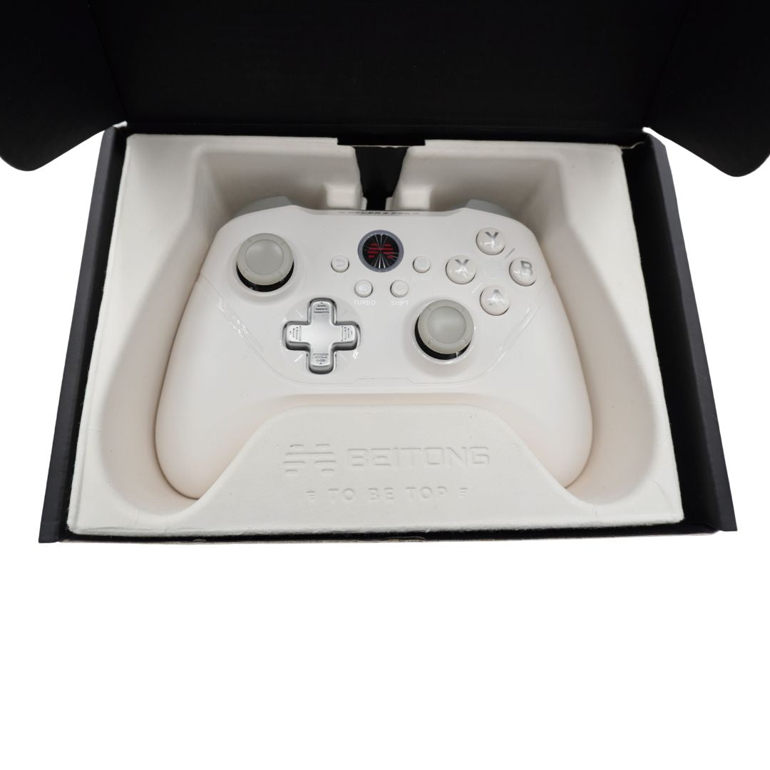 A white BEITONG wireless gaming controller resting in its white molded foam packaging insert inside an open black box, photographed from directly above.