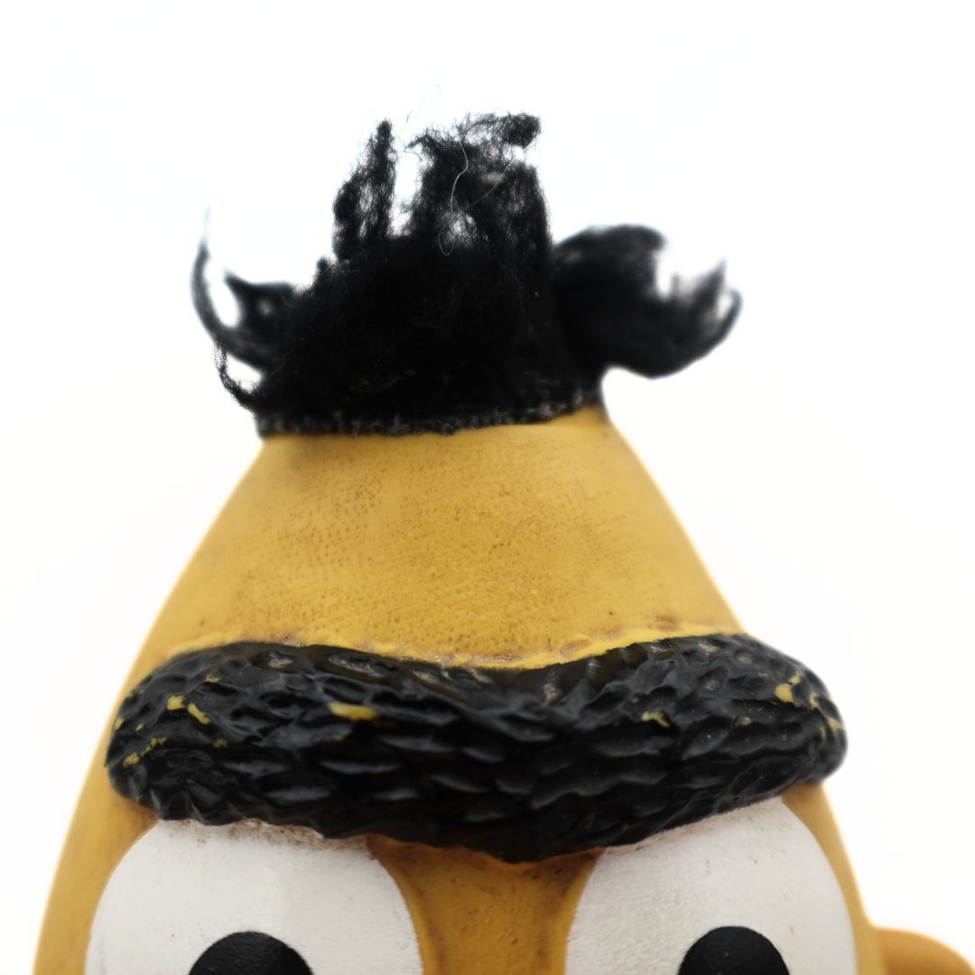 Close up photo of a 1970's Sesame Street Bert puppet, showing its hair and eyebrows