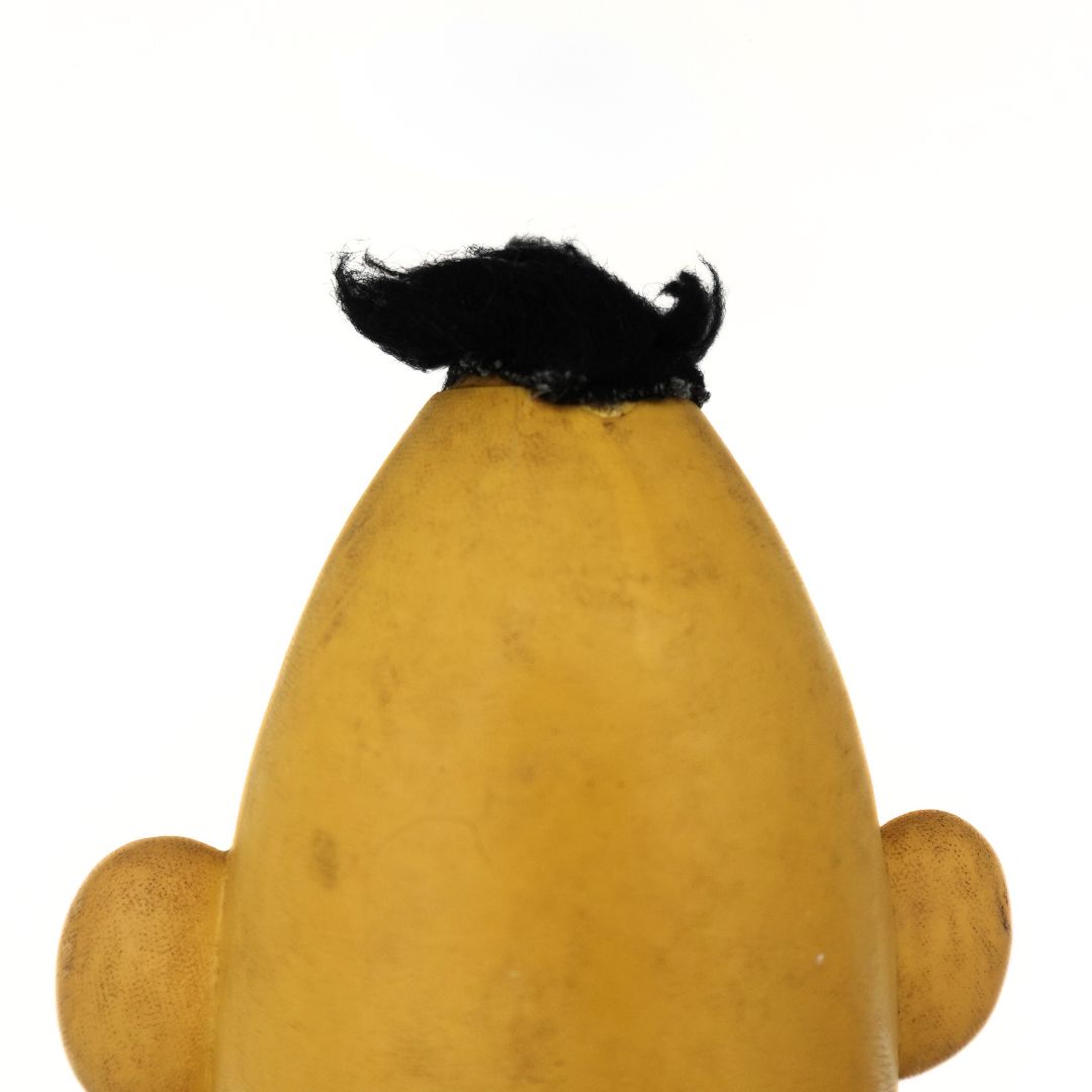 Hairline on a vintage 1970's Sesame Street Bert puppet, with a yellow body and black hair