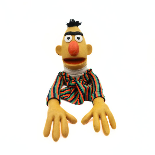 Photo of a vintage 1970's Sesame Street Puppet of Bert, wearing a striped shirt and with a yellow body