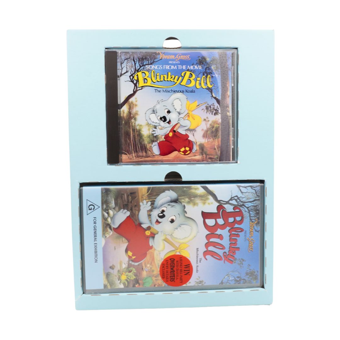 Two cassette tapes with 'Blinky Bill' branding in a display case on a light blue background.
