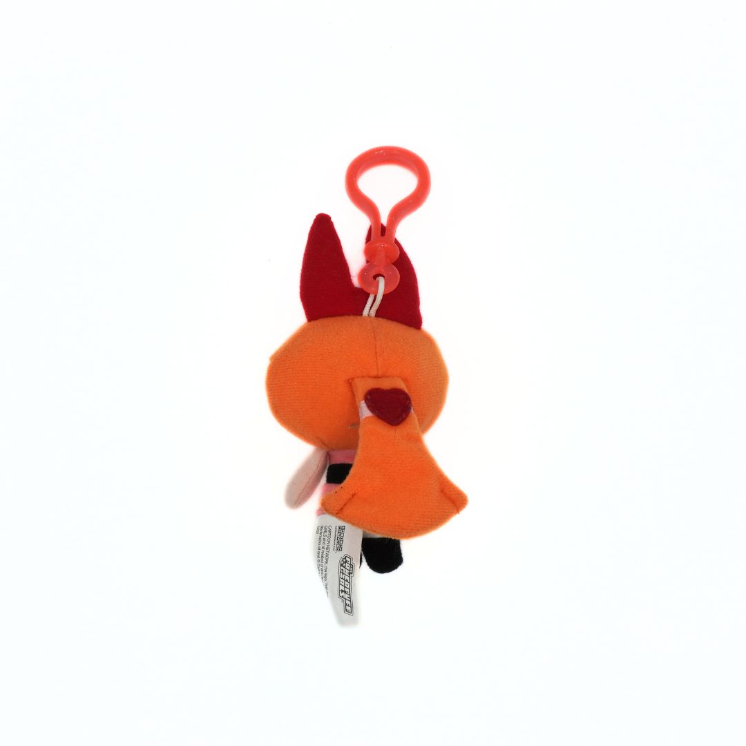 Plush fox toy with a red clip on a white background