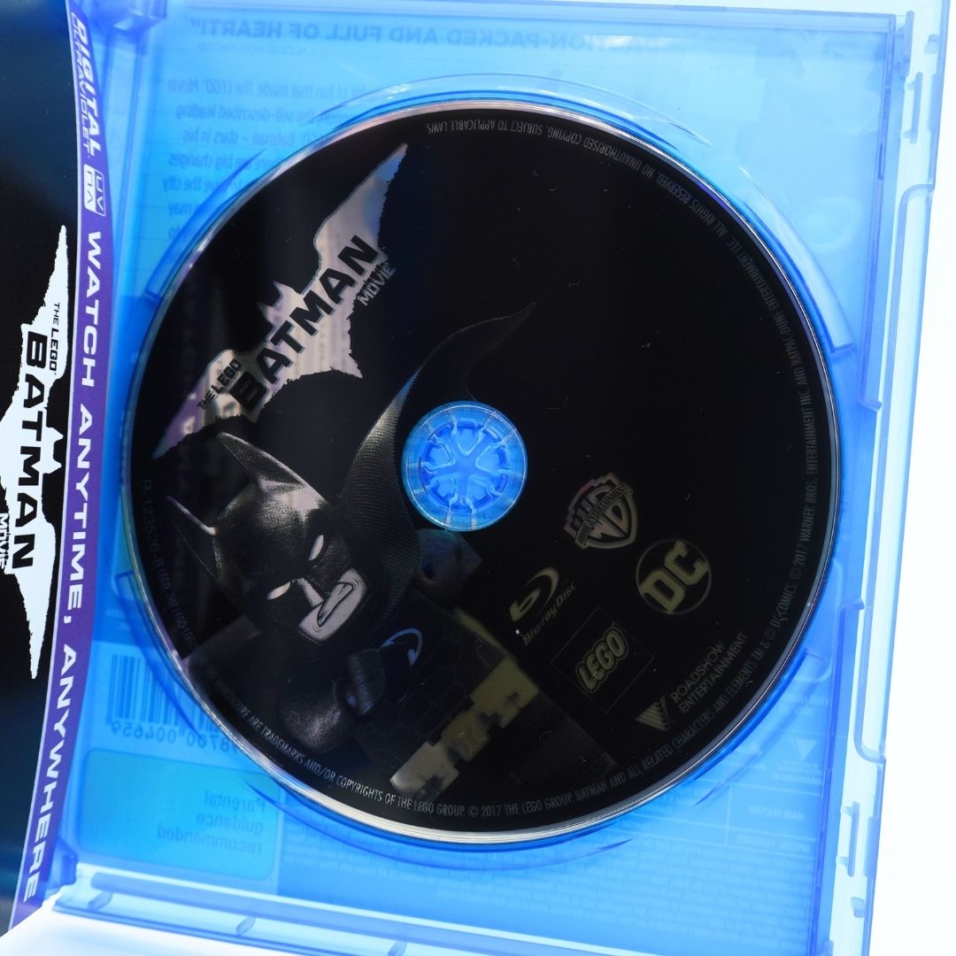 A Batman v Superman Blu-ray disc inside a translucent blue plastic case, with the Batman logo and Batman v Superman text visible on the disc.