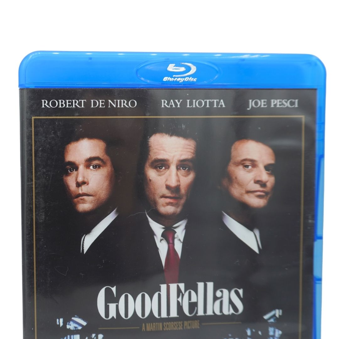 A Blu-ray case for the movie Goodfellas, featuring the blue plastic Blu-ray border and a cover with portraits of Robert De Niro, Ray Liotta, and Joe Pesci on a black background.