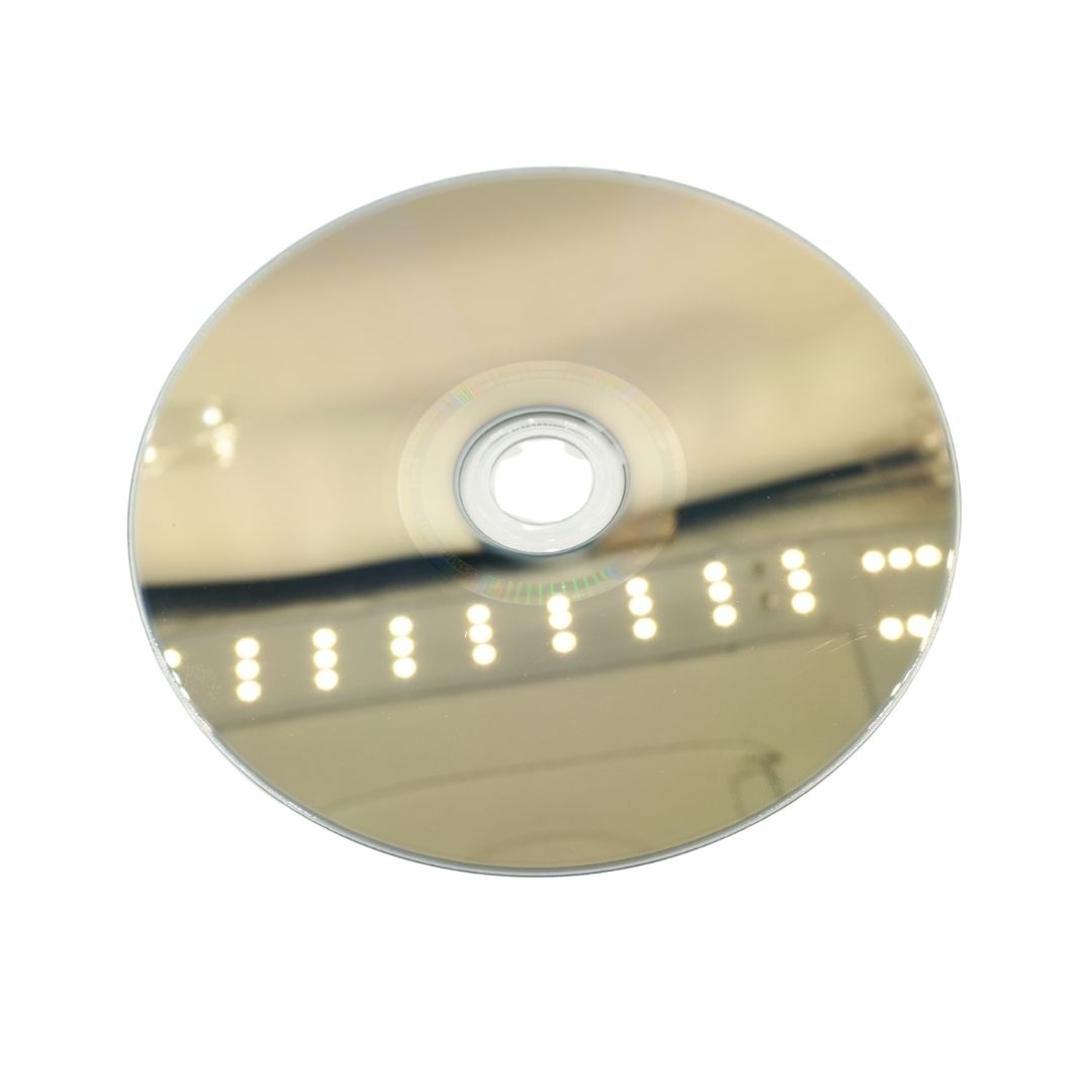 A blank reflective CD-R disc with a gold-toned mirrored surface, centered on a plain white background.