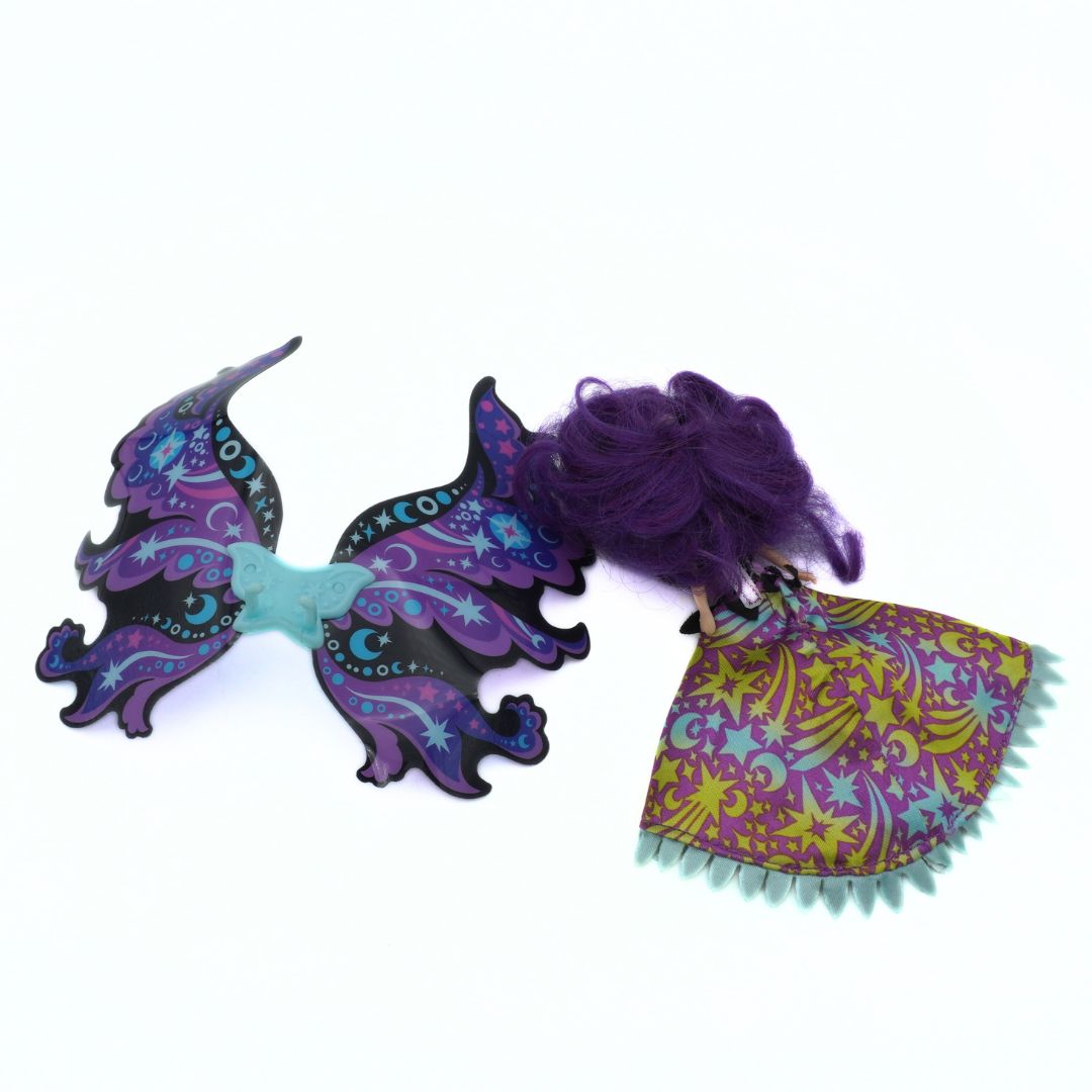 Colorful butterfly-shaped hair clip with purple hair on a white background
