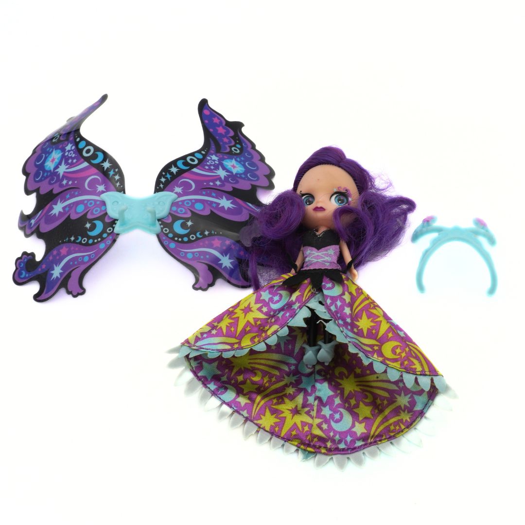 Doll with butterfly wings and colorful outfit on a white background
