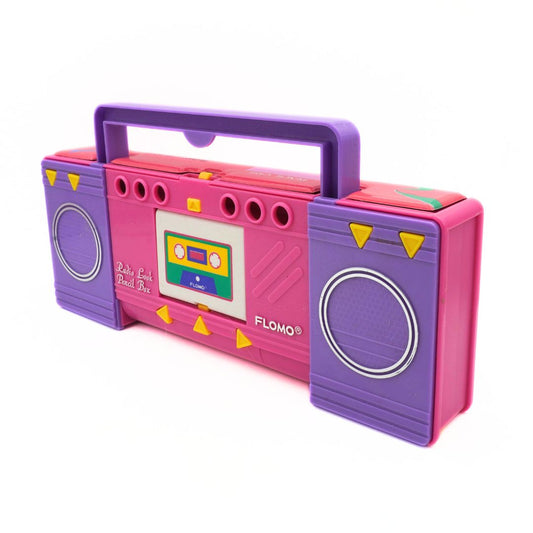 Pink and purple toy boombox with a cassette tape design on a white background