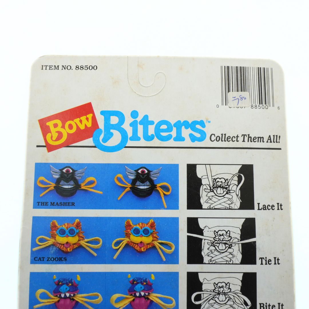 Packaged toy 'Bow Biters' with colorful characters and text on a white background