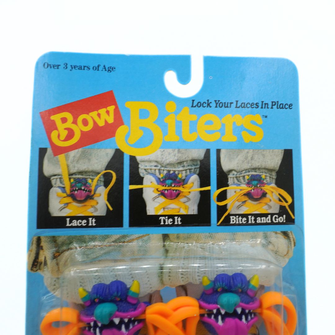 Packaging of Bow Biters with colorful monster designs on a blue background