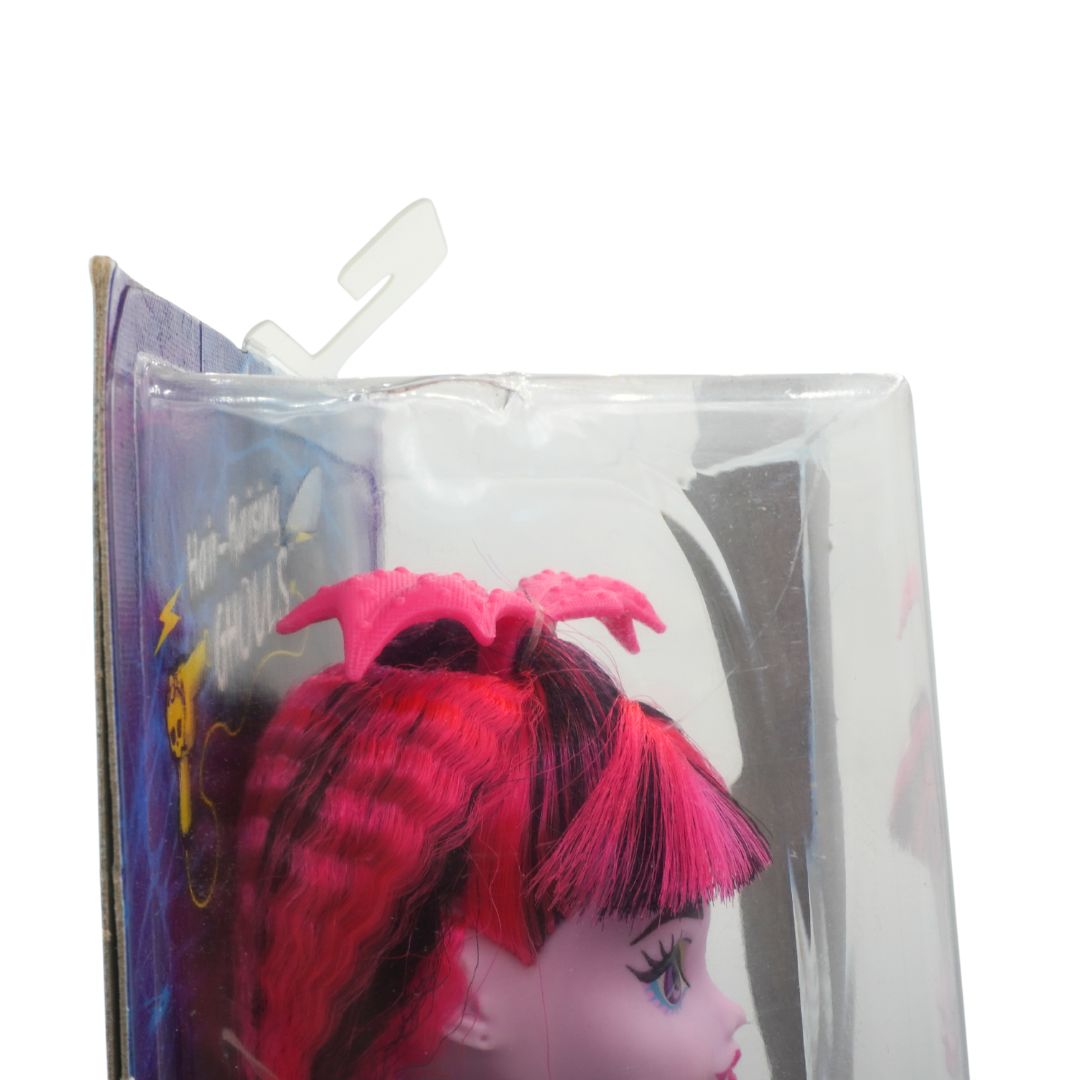 Toy figure with pink hair in a clear packaging sleeve on a white background
