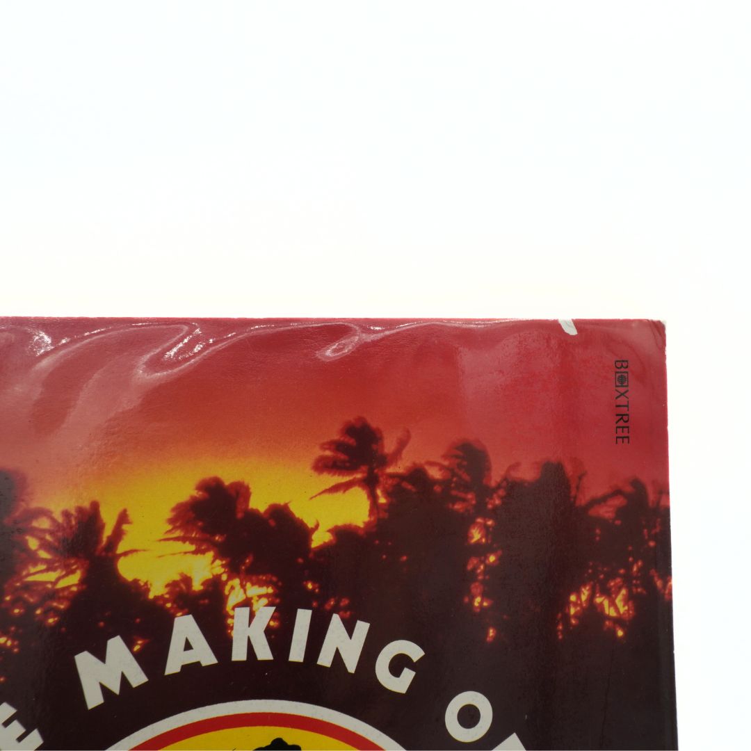 Book cover with palm tree silhouette and sunset design on a red background