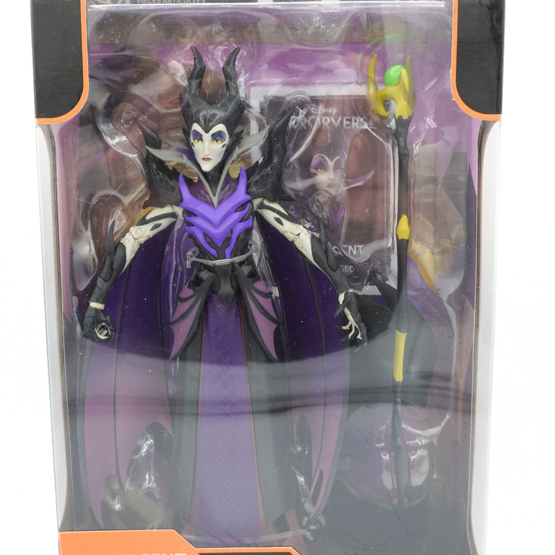Action figure in purple and black costume with accessories in packaging