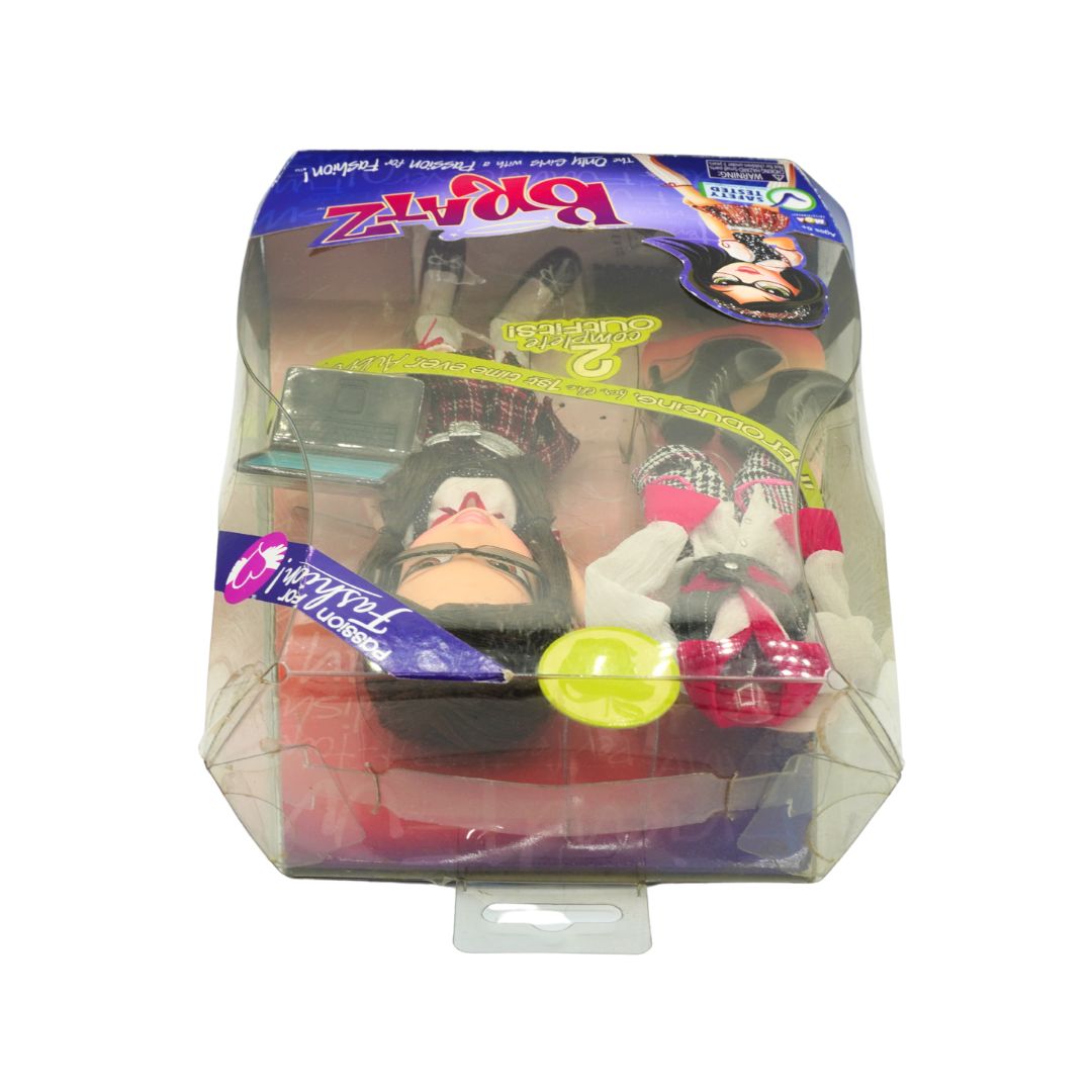 A Bratz doll in its original clear plastic blister packaging with a purple cardboard header card. The doll has black hair, a black and white plaid top, a white skirt, and red and black accessories.