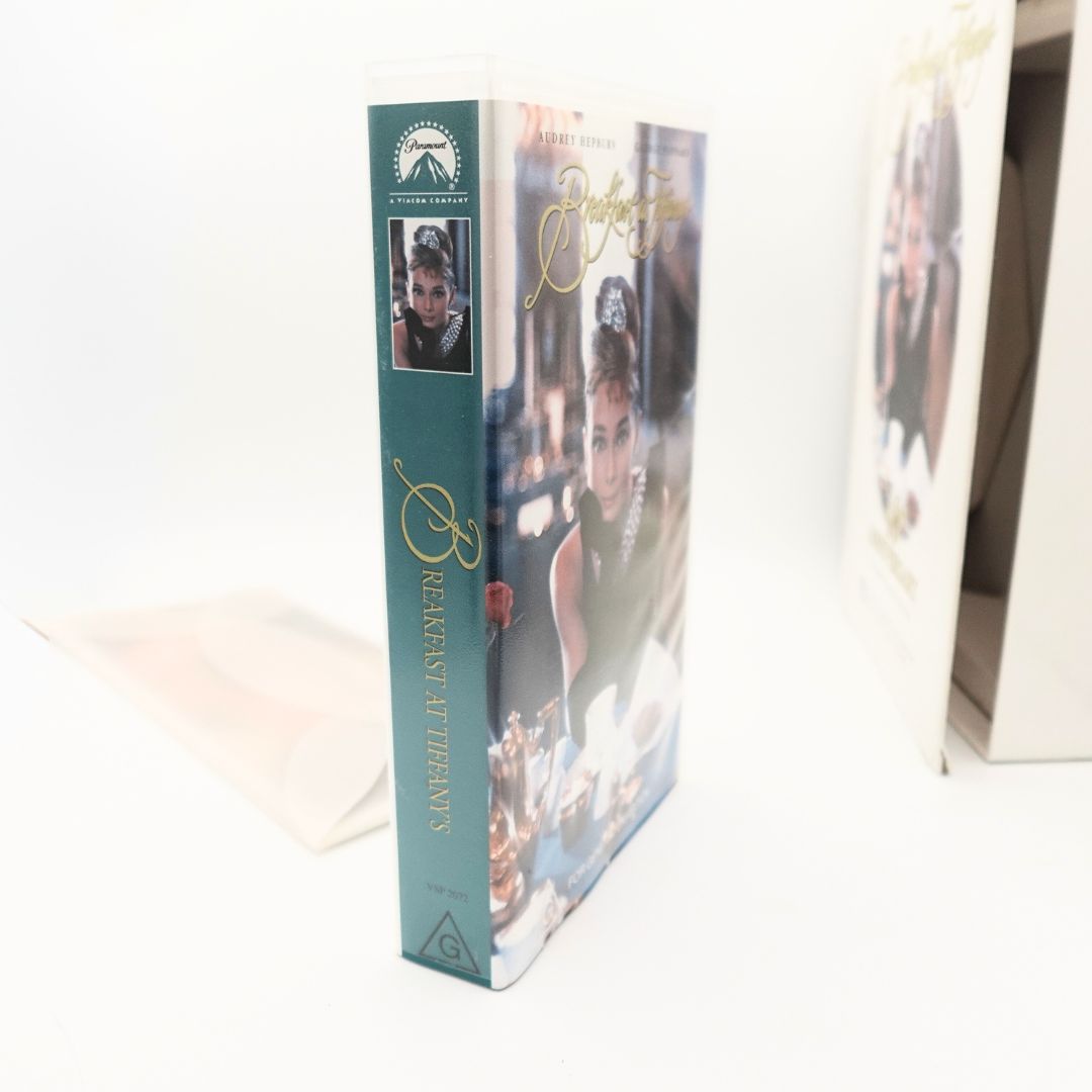 Side on photo of the VHS clamshell case of Breakfast at Tiffanys with a green spine