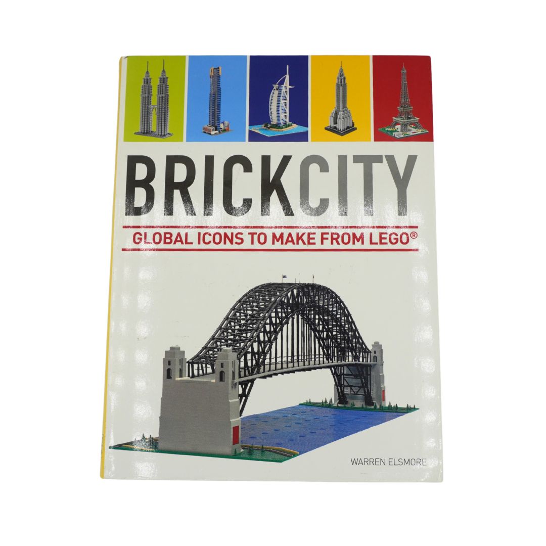 Front cover over a white and colourful book called Brick City by Warren Elsmore