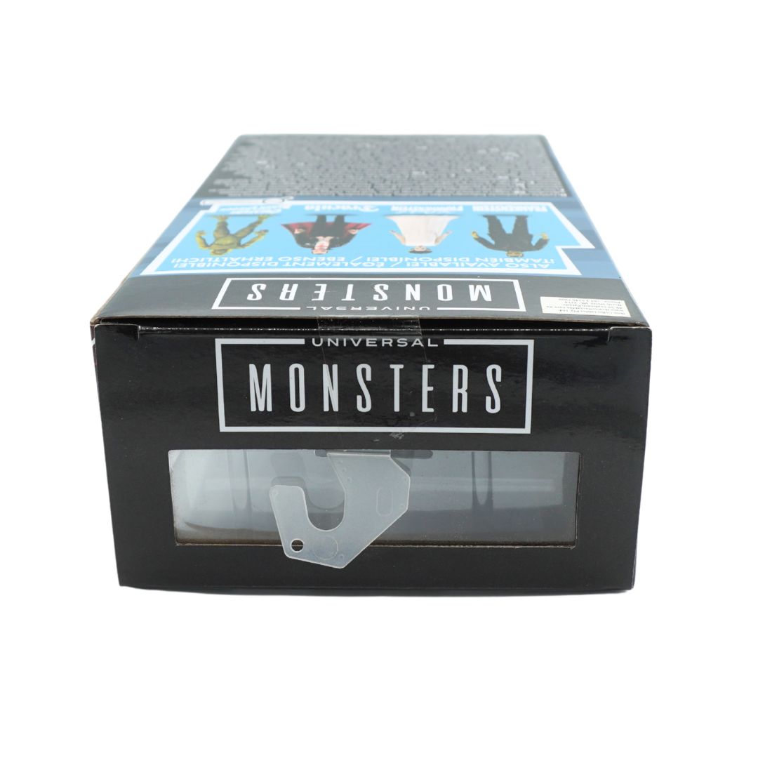 Universal Monsters collectible figure box, featuring a black front with a clear window showing a small figure inside, and a blue illustrated top panel.