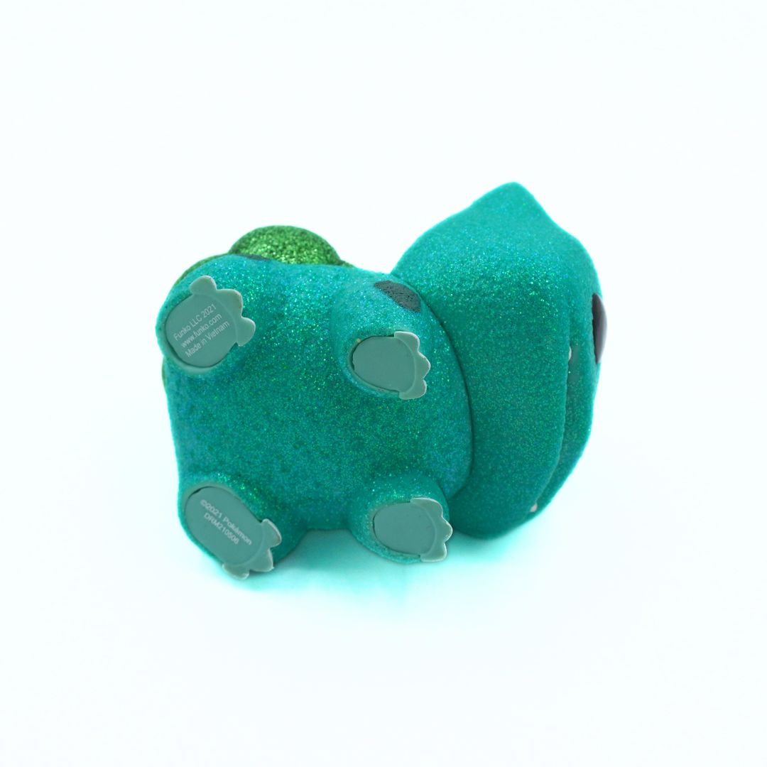 Teal and green plush toy on a white background
