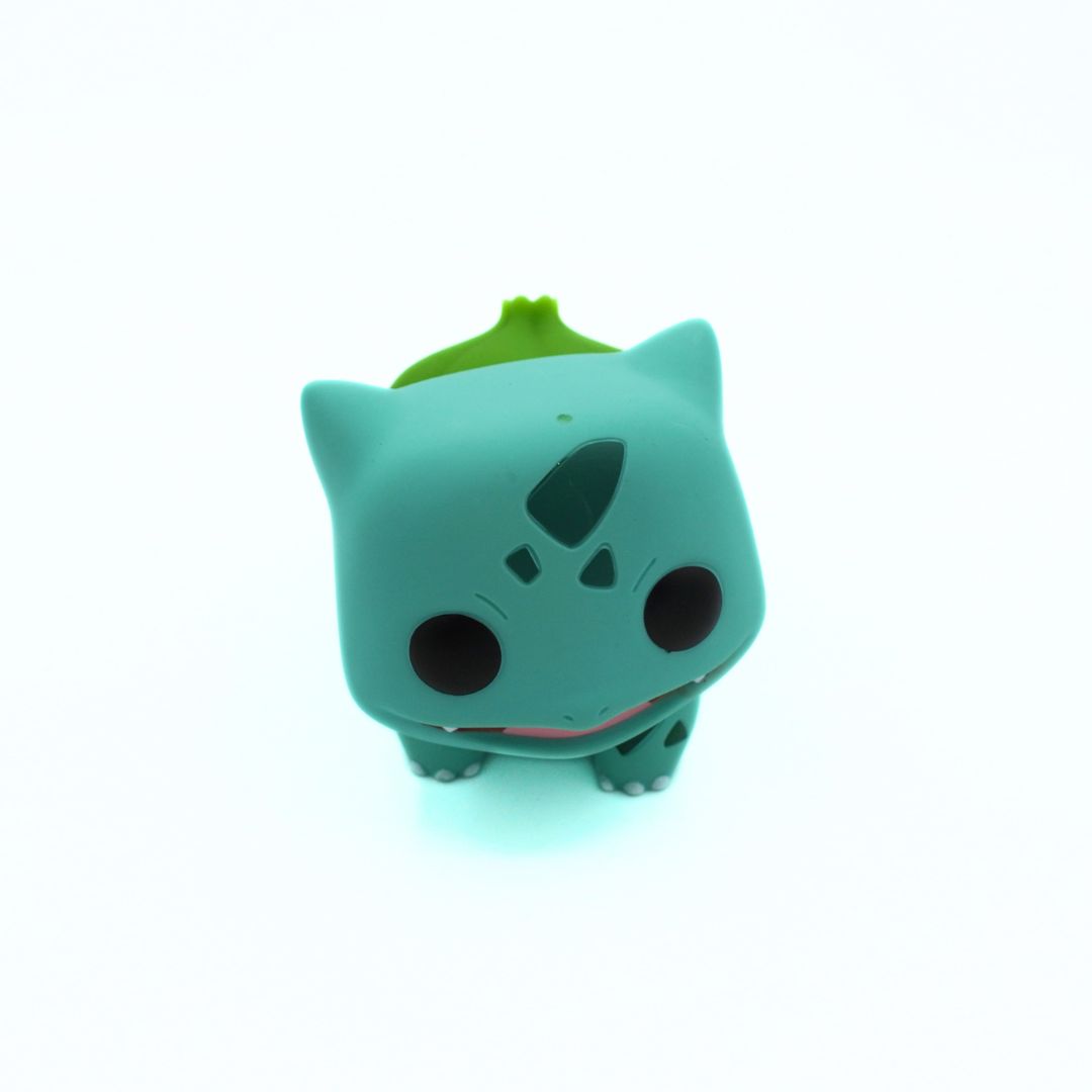 Green cartoon-like figurine with a white background