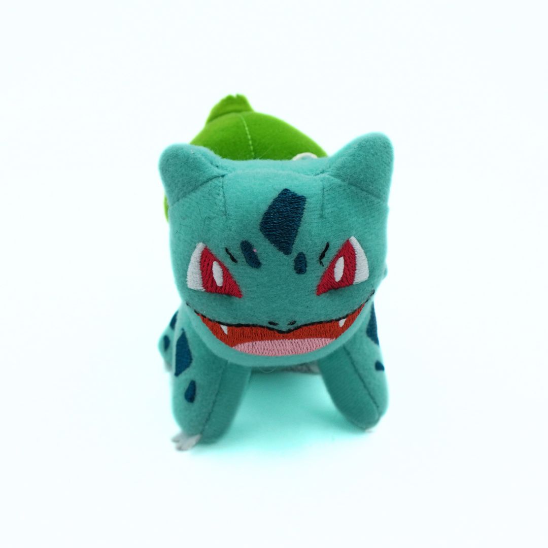 Plush toy of a character with a green hat on a white background