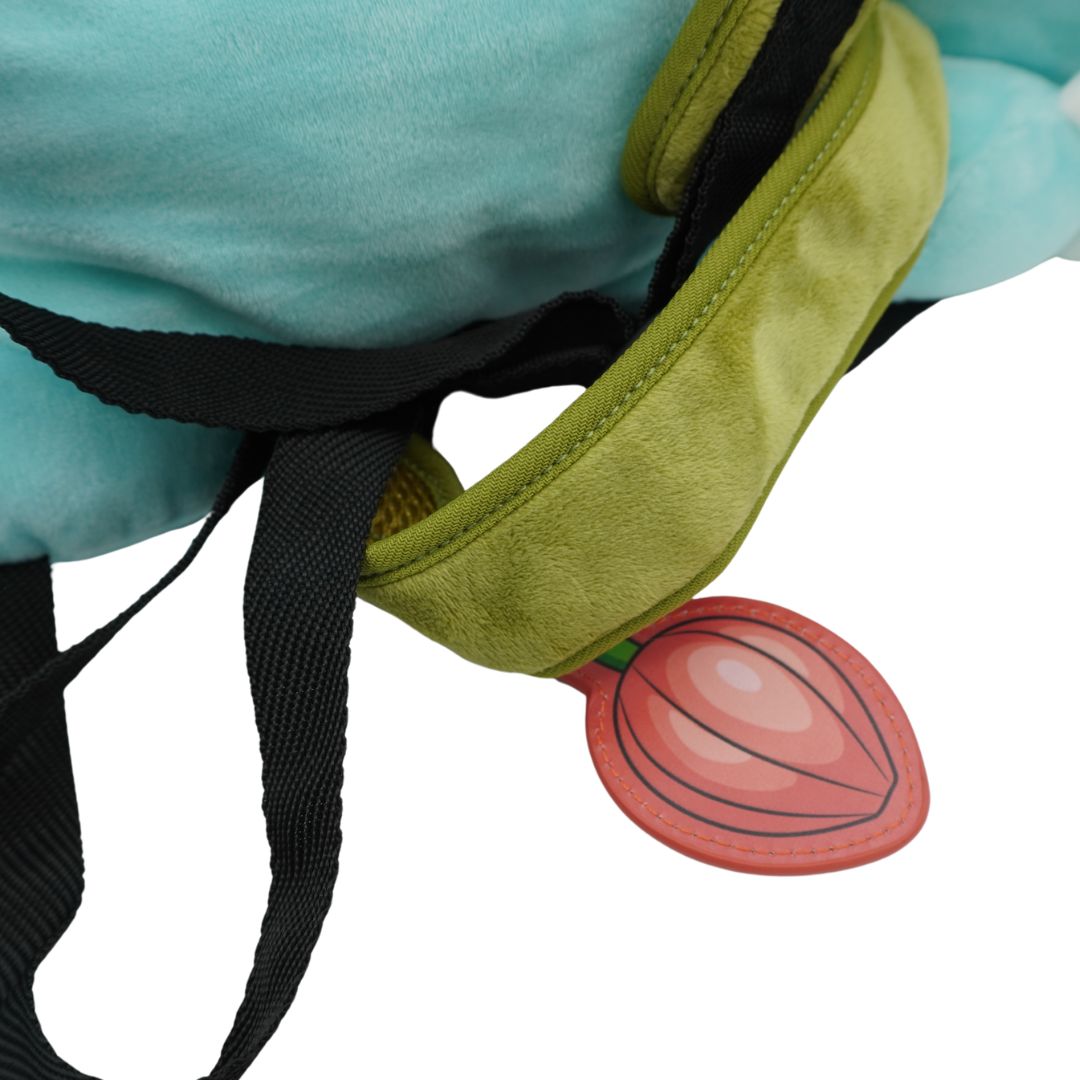 Close-up of a plush toy with a green headband and a pink heart-shaped object on a white background